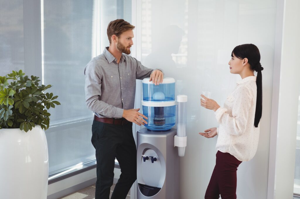 Colleagues interacting while drinking water