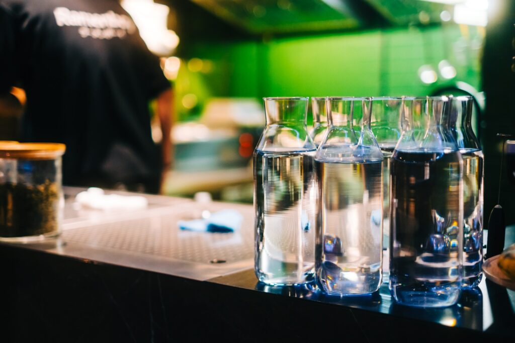 Glass bottles with water on the bar counter in asian restaurant.