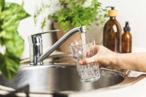 Pouring tap water into the glass. Water purification. Stay hydrated